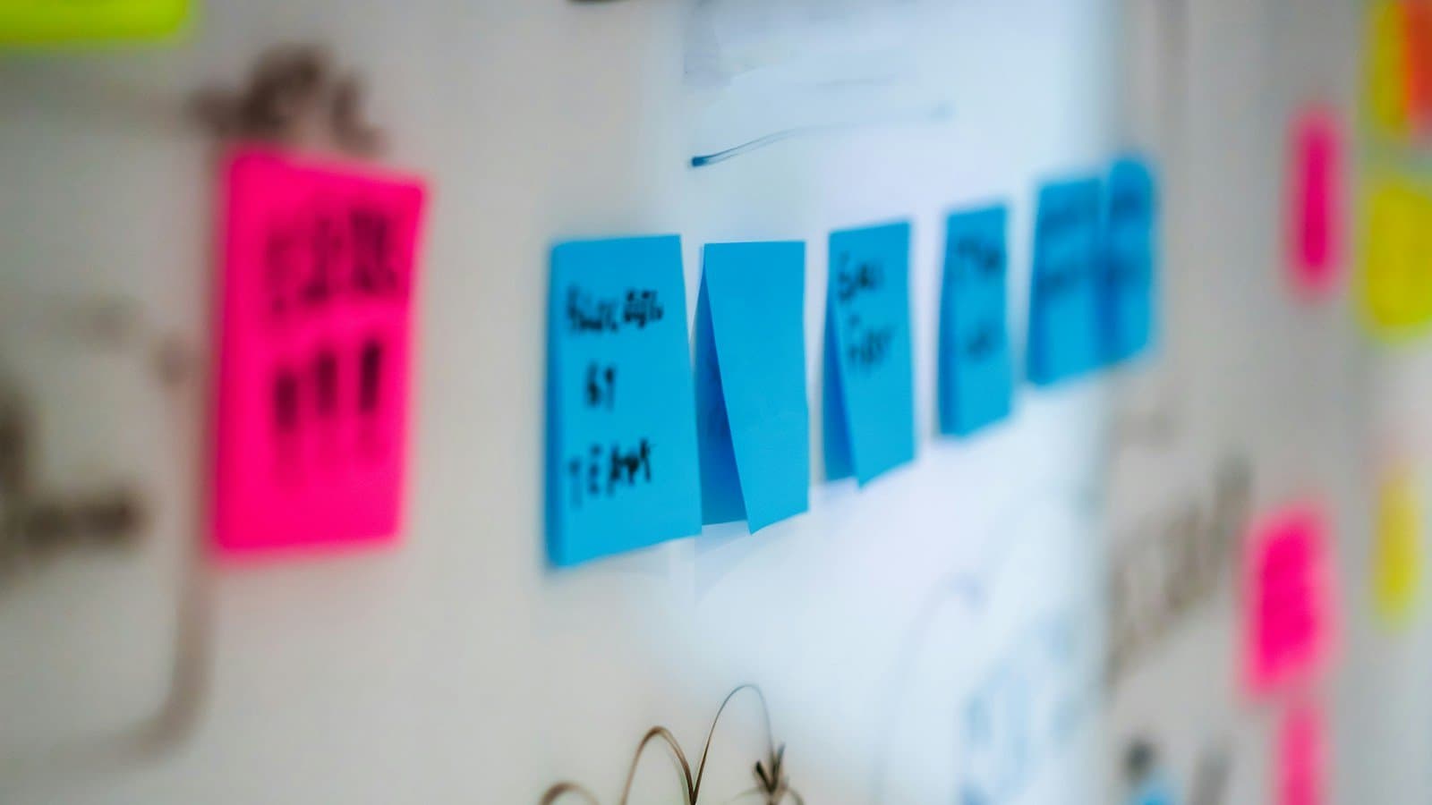 Colored notes arranged on a whiteboard for planning, photographed by Jakub Żerdzicki.